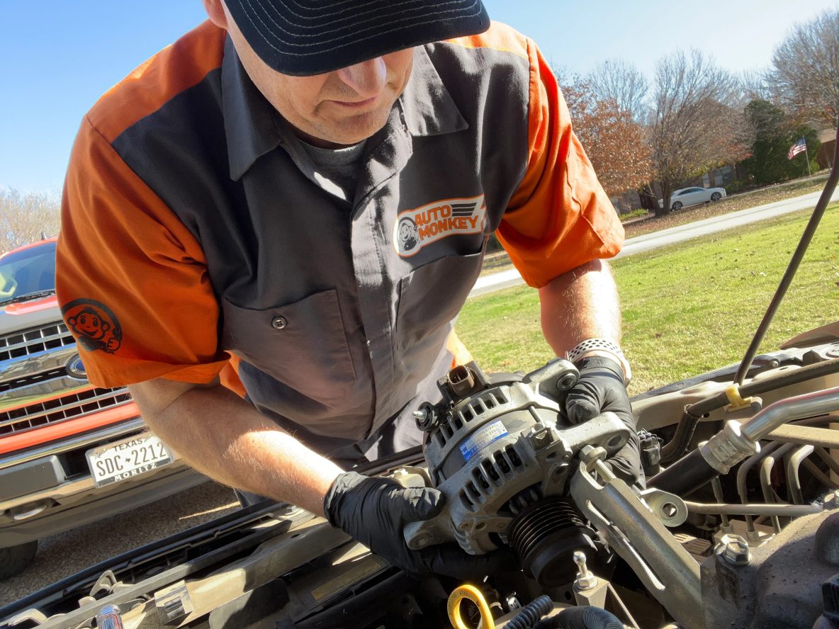 Auto Monkey Mobile Mechanic Replacing an Alternator and doing some automotive car repairs in a driveway at a customer's home